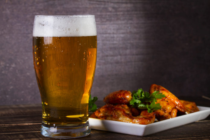 Glass,Of,Beer,And,Chicken,Wings,On,Dark,Wooden,Background