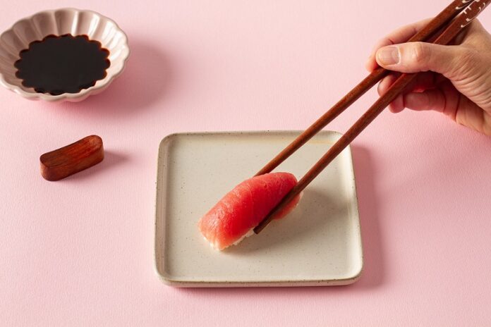 From,Above,Of,Crop,Anonymous,Hand,Taking,Delicious,Sushi,With